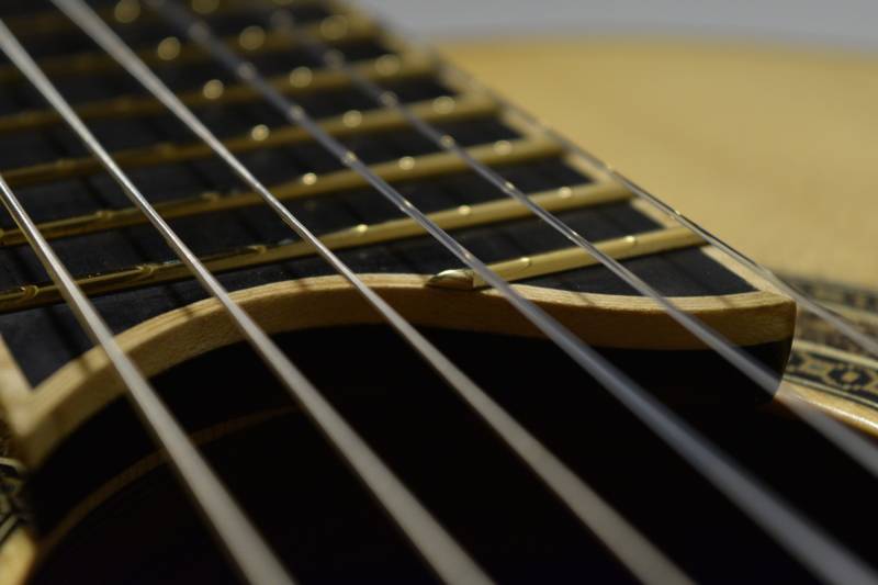 I made a custom mold specifically for gluing the binding to the top of the fretboard