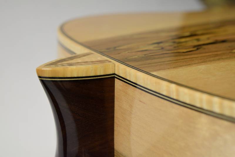 The matching purfling lines of the sides and heal