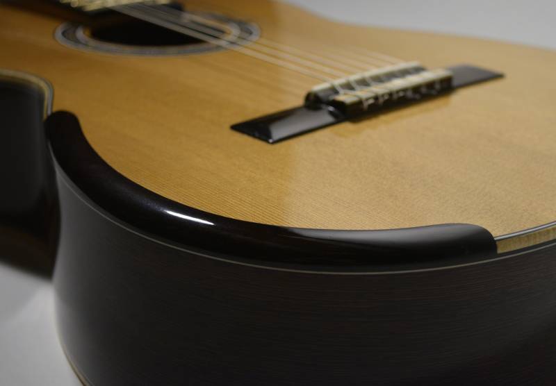 The armrest is embedded into the edge so it doesn't add extra width to the body