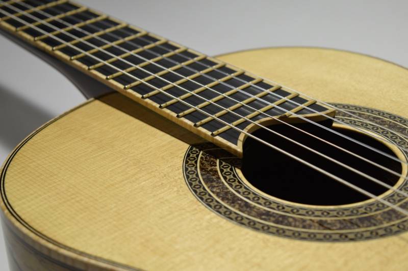 There is a slight elevation in the neck angle in addition to a sloping down of the top that given better access to the upper frets